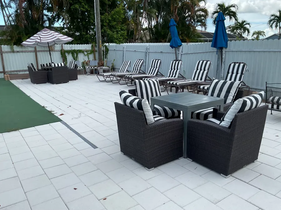 Wicker chairs and a row of black and white striped lounge chairs